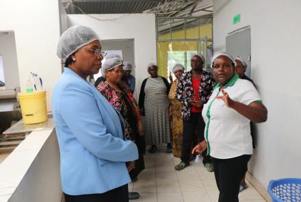 Ms. Mercy Mwende takes WEE Hub team around Sweet and Dried processing plant