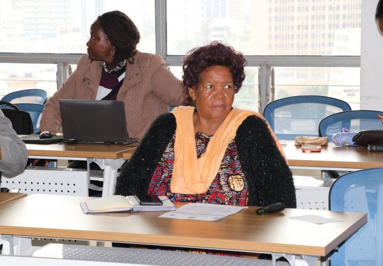 Prof. Wanjiku Kabira follows discussions during meeting