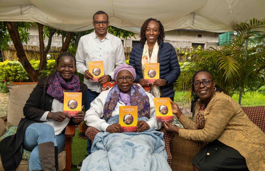 WEE Hub team pose with Prof Eddah Gachukia displaying the book