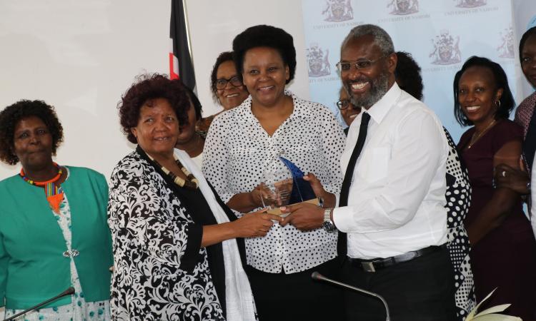 WEE Hub leader Prof Wanjiku Kabira and Prof Mary Kinoti present WEE Hub's Financial Inclusion award to UoN Vice - chancellor Prof Stephen Kiama