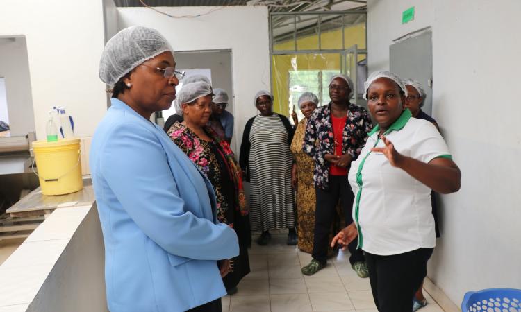 Ms. Mercy Mwende takes WEE Hub team around Sweet and Dried processing plant