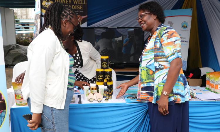 Mrs. Rose Marete and Breanda, a WBI exhibitor at WEE Hub exhibition booth